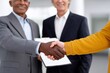 © Gatherina - Business people shaking hands closing successful deal