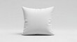 © MdRahat - A simple square white pillow sitting on a white surface in a studio with soft lighting all around