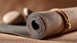 © Crocodilchik - Yoga mat rolled up on light gray background minimal fitness concept