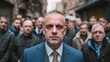© Oleksandr - A man in a blue suit stands out in a crowd, his intense gaze and formal attire contrasting with the casual onlookers on a city street, creating a striking visual narrative.