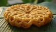 © ghoffar anshory - Golden brown traditional Indian sweet snack on a banana leaf with water droplets