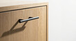 © Iuliia - Modern wooden cabinet with sleek handle detail and soft lighting for interior design concept