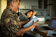 © Marko Geber - Mature father and young daughter stressed over bills in kitchen