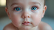 © Stacy - An intimate close-up of a baby's face with bright blue eyes looking directly at the camera. The focus is on capturing the innocence and purity often associated with early childhood.
