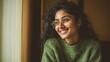 © Khawla - Smiling Indian Woman in Green Sweater by Window