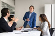 © fizkes - Friendly smiling experienced businessman involve diverse executives in boardroom discussion
