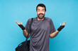 © luismolinero - Young sport man with beard over isolated blue background with shocked facial expression