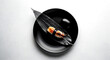 © Visions of Diversity - Minimalist flat lay, a monochrome composition a black ceramic plate with a single piece of nigiri with squid (ika), a charcoal-gray bamboo leaf, and a black stone