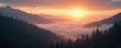 © miss irine - Misty mountain valley at sunrise with orange sky. Clouds cover lowlands between evergreen trees on slopes. Sun crests horizon over calm, serene natural landscape.