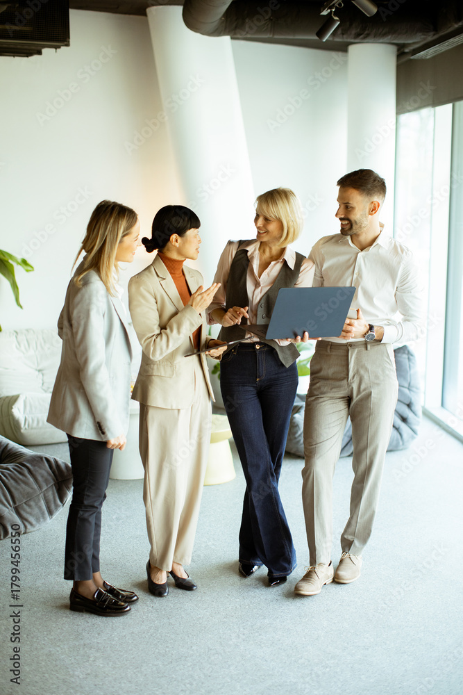 Professional team collaborating in a modern office setting during ...