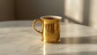 © Nhoeb - Elegant Golden Mug with Tea on Marble Table in Soft Natural Light