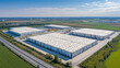 © MDNUR - Panoramic aerial view of a large industrial park with multiple warehouses and loading bays, showcasing logistics and distribution