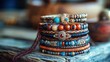 © Soknea - A stack of colorful beaded bracelets with wooden beads and metal accents, arranged on a rustic wooden surface with a blurred background.