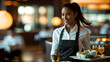 © Bernd Schmidt - Waiter Woman Female Smiling Brown Skin Serving Tray Drinks Restaurant Motion Blurred Background Warm Lighting Focus Efficiency White Shirt Black Apron Modern Interior Generative AI