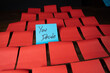 © Zac - Blue sticky notes in a grid pattern of red sticky notes on a dark wood surface with text reading You Decide.