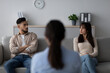 © Prostock-studio - In a counseling clinic, a female psychologist guides an arab couple through a therapy session. The couple sits on a couch, facing each other, while the psychologist observes their interaction.
