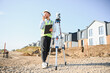© Serhii - Engineer communicating on construction site with total station