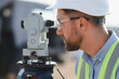 © Serhii - Engineer surveying construction site with a total station