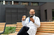 © Jelena - Doctor taking coffee break checking smartphone