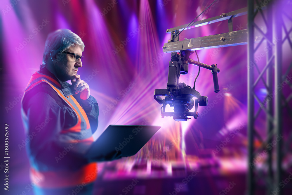 Stage Camera Setup Stage production technician configures a robotic camera system using a ...