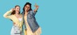 © Pixel-Shot - Happy young women showing victory gesture on blue background with space for text