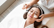 © Pixel-Shot - Beautician applying mask on face of young Asian woman in spa salon