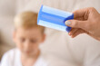 © Pixel-Shot - Mother with head lice comb against her little son with pediculosis at home, closeup