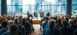 © hao - Business experts give presentation to audience in modern conference hall. Attendees listen attentively to speakers on stage. Blurred background suggests large room with windows urban view. Likely