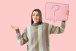 © Pixel-Shot - Young woman holding speech bubble with question mark on pink background