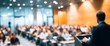 © hao - Audience with blurred speaker giving presentation in bright university workshop lecture hall background. Scientific conference presentation event, training, meeting. High quality