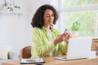 © Pixel-Shot - Young African-American woman using mobile phone to search online at home