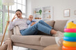 © Pixel-Shot - Tired mother with her baby suffering from postnatal depression on sofa at home