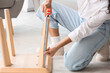 © Pixel-Shot - Young woman measuring coffee table at home