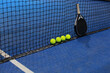 © Mau Salas - Net, balls and paddle racket on the blue court