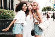 © halayalex - Three young beautiful smiling hipster female in trendy summer clothes.Sexy carefree multiracial women posing on the street background.Positive models having fun in sunglasses. Cheerful and happy