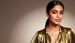 © DWIJ - A beautiful indian woman with dark hair and makeup poses in a golden shirt