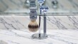 © Angelo - Elegant shaving set with brush and razor on a marble countertop in a bright bathroom setting