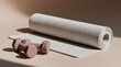 © sam richter - Rolled yoga mat positioned beside small dumbbells creates minimalist fitness composition.