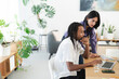 © Studio Marmellata - Diverse colleagues collaborate on a laptop in a bright, modern office. The man types while the woman reviews content, discussing their project.