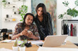© Studio Marmellata - A diverse man and woman collaborate on a creative project in a bright, modern office. He shares information on his smartphone with her, while she observes the screen