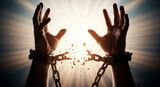 Man breaking free from chains with upward reaching hands. Concept of freedom, liberation, and overcoming adversity. Day for the Abolition of Slavery