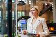 © Westend61 - Businesswoman with tablet in modern office looking serious