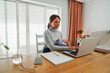 © DisobeyArt - Young mother working at home while feeding her infant son - Smart working and family concept - Focus on mom face