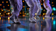 © Laura - Faceless dancers in white cargo pants moving on a dim dance floor, background lights intentionally defocused into soft bokeh, with copy space