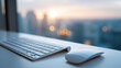 © Anastasiya Marchenko - Close-up of modern wireless keyboard and mouse on desk with blurred cityscape and sunset background