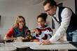 © Halfpoint - High school students working on robotics project with their teacher.