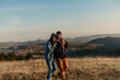 © La Famiglia - Happy couple embracing in fields enjoying nature landscape