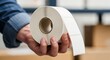 © MSTLAYLI - Hand holding a roll of blank white adhesive labels for shipping and product packaging