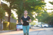 © themorningglory - Beautiful asian sport active woman sprint run on city road morning sun light