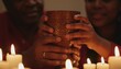 © Olga Gorkun - Hands holding carved wooden cup by candlelight represent cultural unity and heritage. Concept of ritual gathering and shared tradition